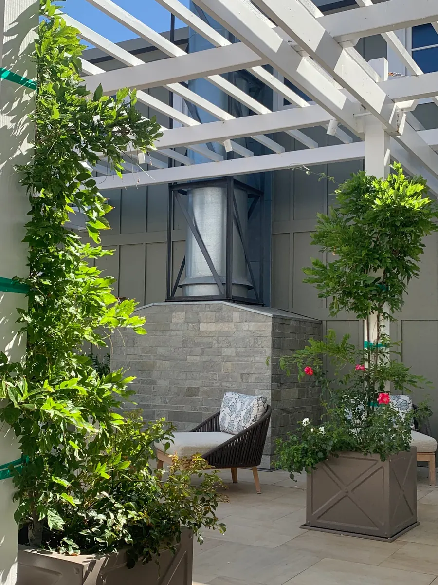 Pergola patio with lush garden and seating